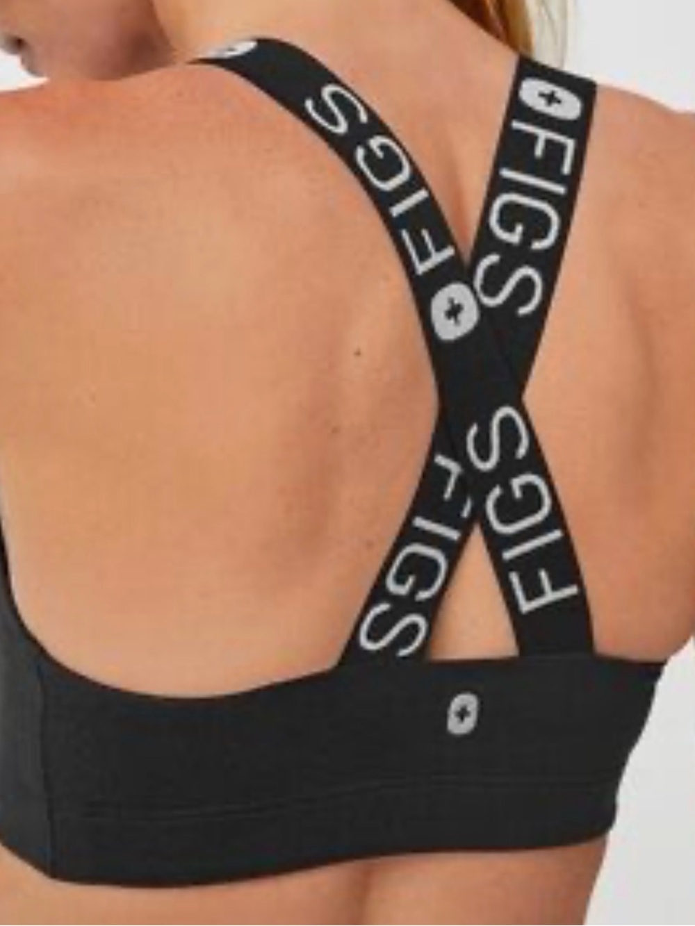 black FIGS Performance Underscrub Sports Bra featuring branded crossback straps
